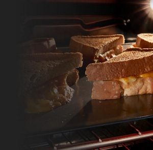 Grilled cheese on a pan under a broiler