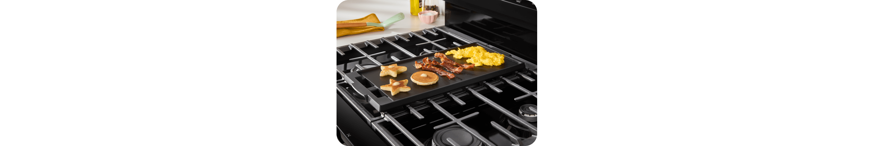 Breakfast items cooking on a griddle on a Whirlpool® Range