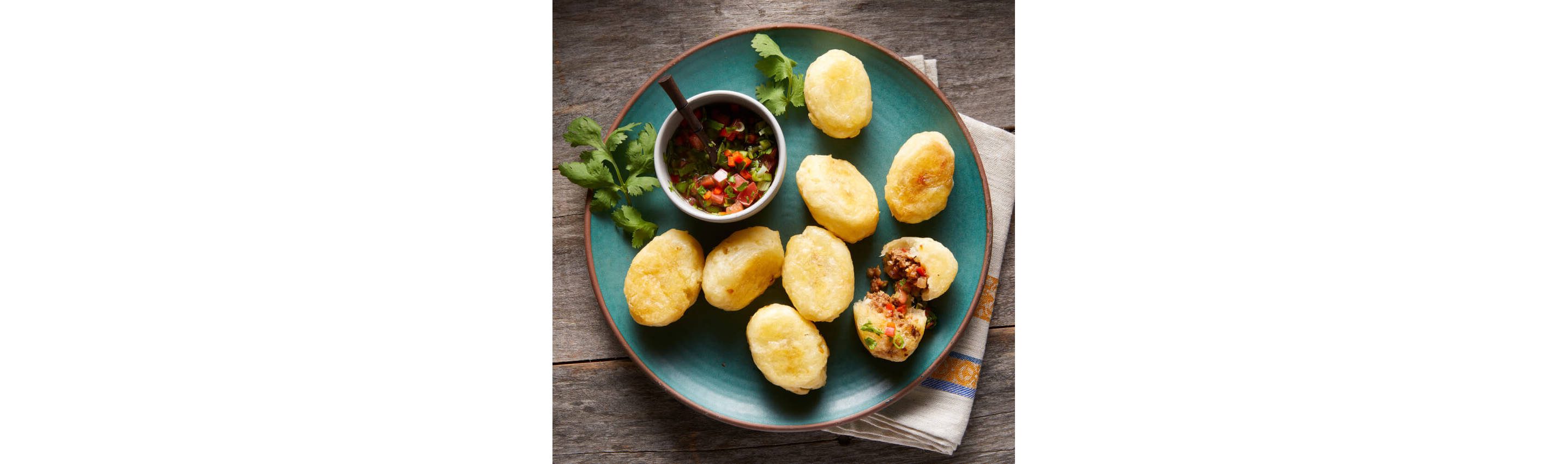 A plate of Carimañolas (baked cassava stuffed with beef and vegetables)