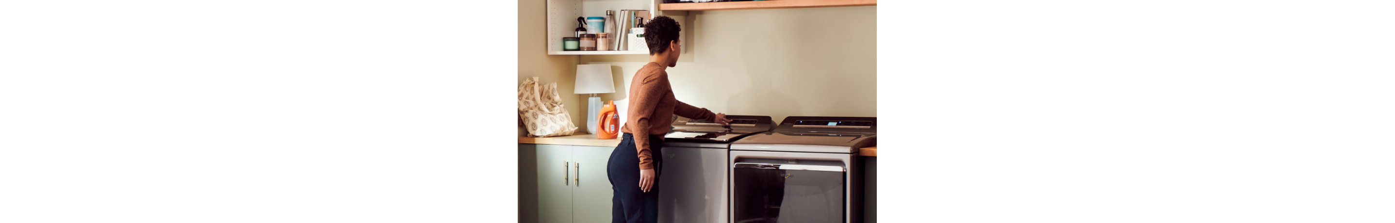 A person starting the washer
