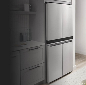 A bright, white kitchen with a 4-door refrigerator