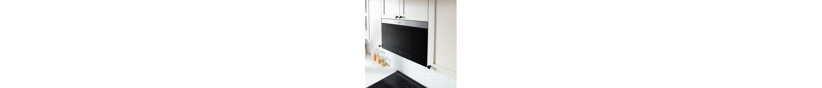 A Whirlpool® Over-the-Range Microwave flush with cabinetry