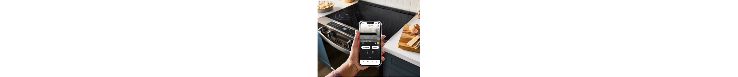 A hand holding a cell phone in the foreground with an induction cooktop in the background