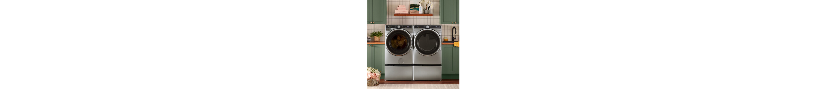 A Whirlpool® Washer and Dryer Set surrounded by green cabinetry