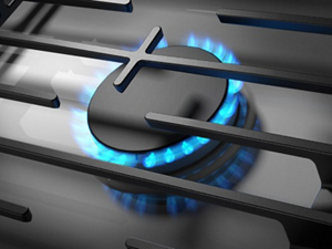 A close-up of a lit burner on a cooktop
