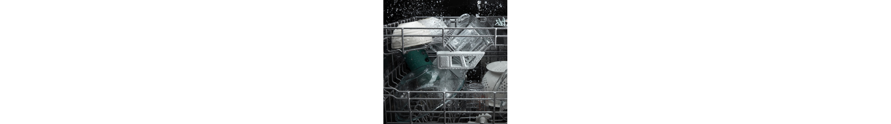 A closeup of the interior racks of a Whirlpool® dishwasher during a wash cycle.