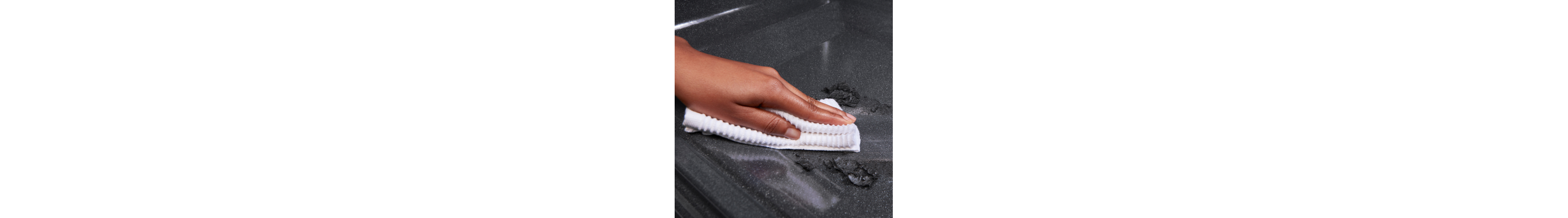 A hand scrubbing the oven