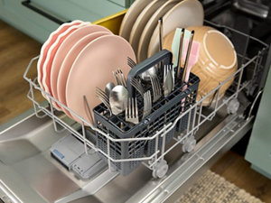 Open lower rack of a dishwasher filled with dishes