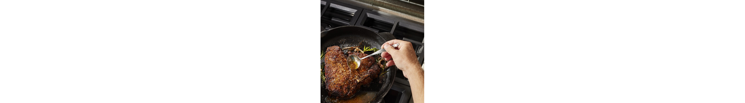 Someone drizzling juices over meat