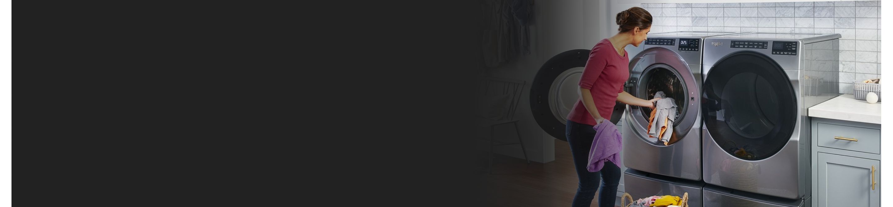Woman loading clothing into front-load washer