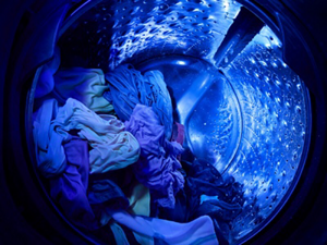 The blue glow of UV light inside a Whirlpool® Washer with UV Clean Technology