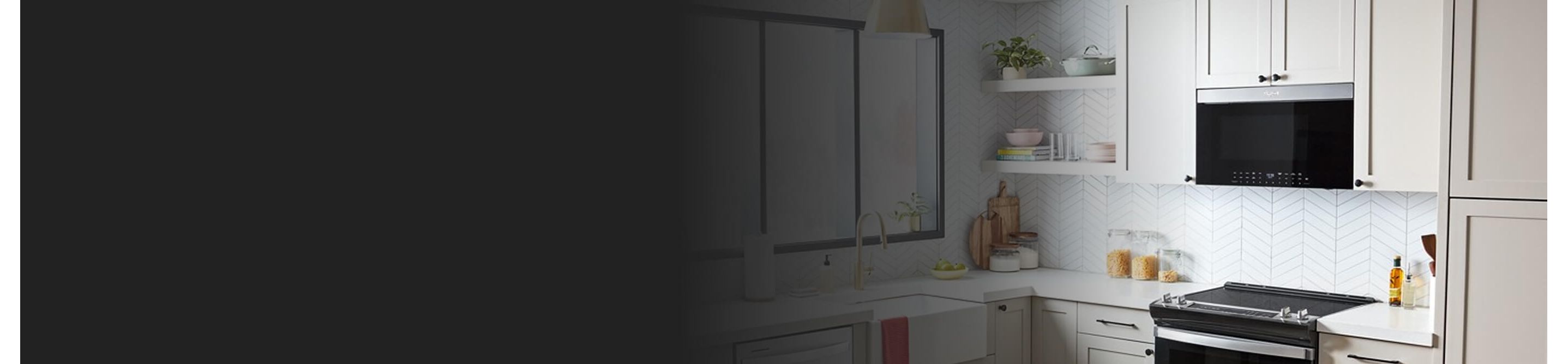 Whirlpool® Over-the-Range Microwave above electric range in white cabinetry
