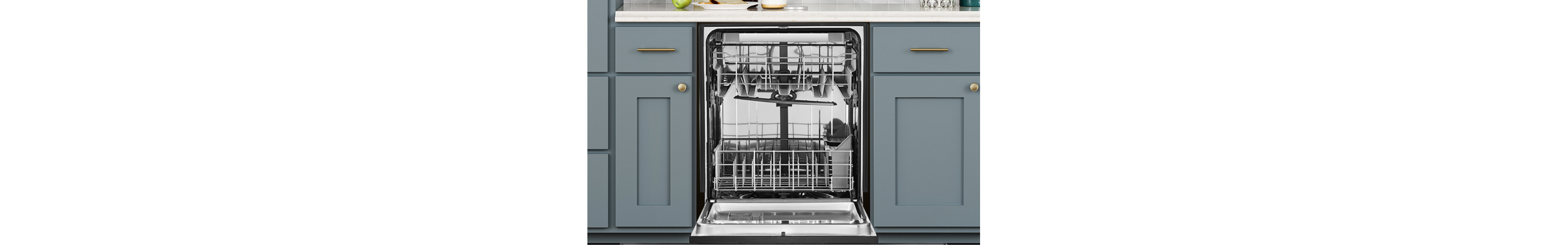 Open empty dishwasher among kitchen cabinets
