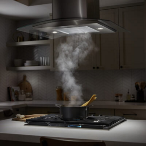 Steam from a cooktop moving up into a range hood above