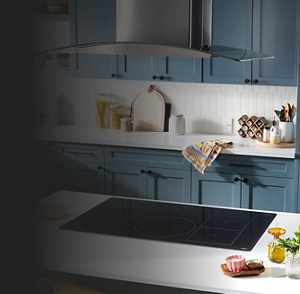 A canopy range hood over a kitchen island