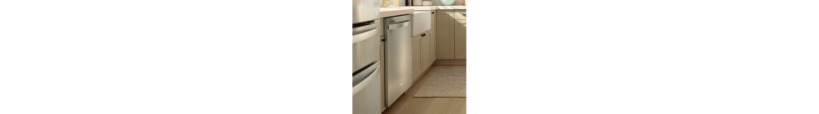 A stainless steel Whirlpool® Dishwasher in a kitchen with light cabinets