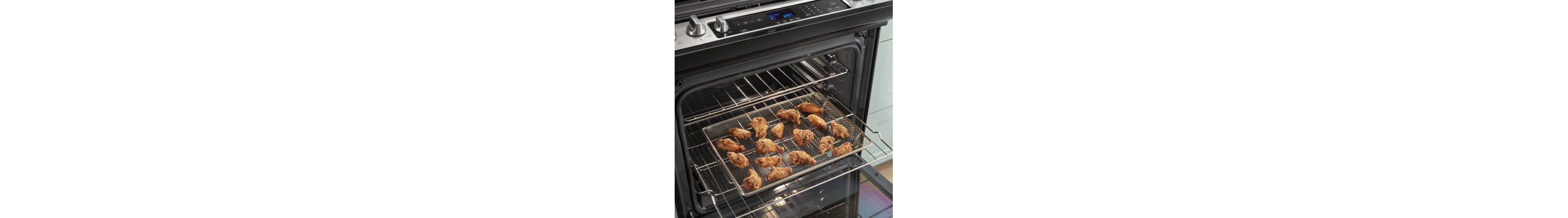Chicken wings cooking in an air fry oven