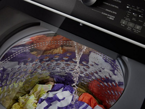 Clothes in a washer with water pouring in