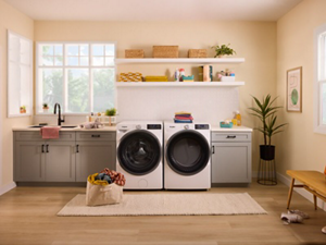 A laundry area with a white Whirlpool® Front Load Washer and Dryer