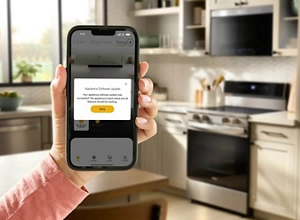 A hand holding a phone with the Whirlpool® App pulled up