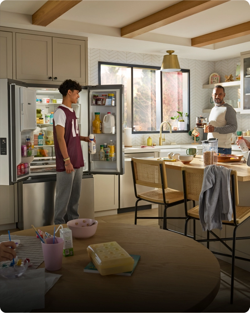 Two people preparing breakfast for their family inside a bright, modern kitchen
