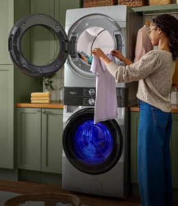 A person pulling clothes out of the dryer