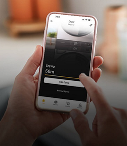 A stacked laundry set with an open Whirlpool® app in front